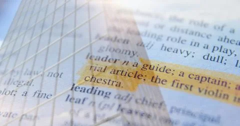 Showing highlighted dictionary entry 'leader' reflecting skyscraper facade over Stock Illustration