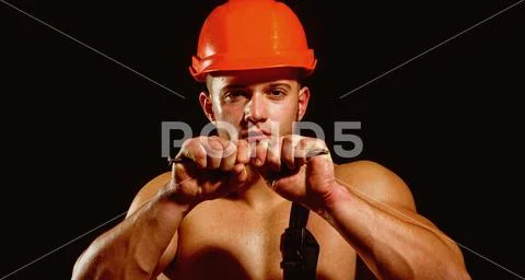 Showing his strength. Construction worker or builder with biceps triceps Stock Photos