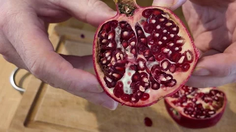 Showing the Inside of a Cut Pomegranate Video stock 348108415