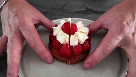 Showing inside of strawberry tartlet after cutting Stock Footage 345340433