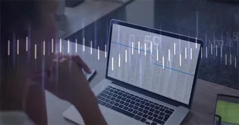 Showing laptop screen displaying spreadsheet columns at home desk, with phone Stock Photos