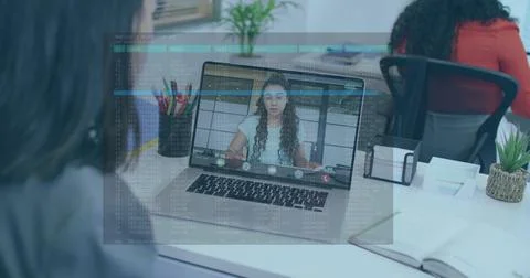 Showing laptop screen featuring remote participant at modern office desk, code Foto stock