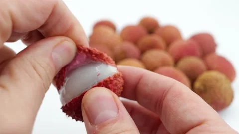 Showing a lychee and its pulp to the camera Stock Footage 146171087