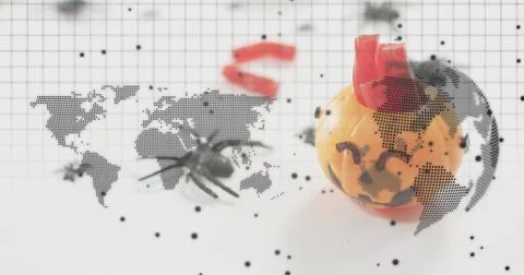 Showing mini jack-o'-lantern wearing red crown on grid mat, spider prop and map Stock Photos
