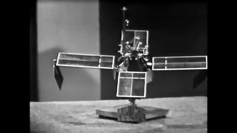 Showing a model, actor John Fitch explains discoveries made by the Mariner IV Stock Footage