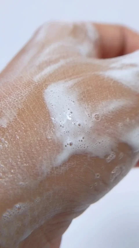 Showing palm of hand that has been soaped. Vertical close up view. Stock Footage 335296963