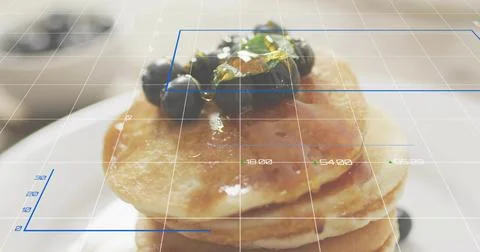 Showing pancake stack shining with syrup on white plate, with blueberries and Stock Photos