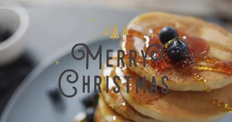 Showing pancake stack shining on tabletop with blueberries, maple syrup, Merry Stock Photos