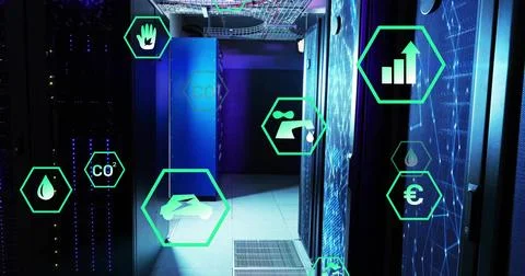 Showing server racks lining data center corridor under cable trays, with green Stock Photos