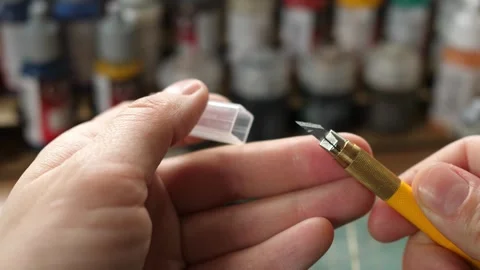 Showing sharp modeling hobby knife, painting minis rpg game, cleaning moldlines Stock Footage 260822066