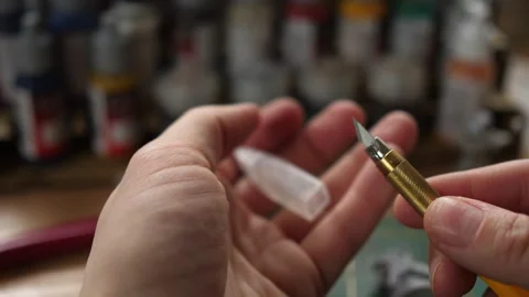 Showing sharp modeling hobby knife, minis for rpg game, cleaning moldlines Stock Footage 260825452