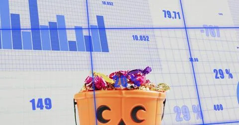 Showing small orange jack-o-lantern bucket on studio tabletop, holding foil Stock Photos
