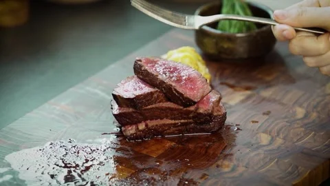 Showing Texture and Tenderness of Medium Rare Steak Stock Footage 334358121