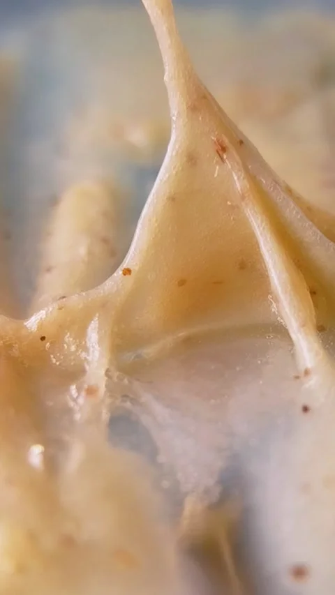 Showing thickness level of moisturizing cream using a metal tool. Close up .. Stock Footage 336238666