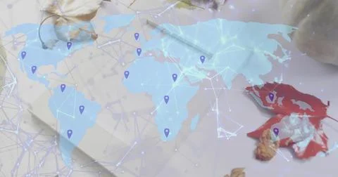 Showing translucent map across desk, displaying network lines, purple pins, n Stock Photos