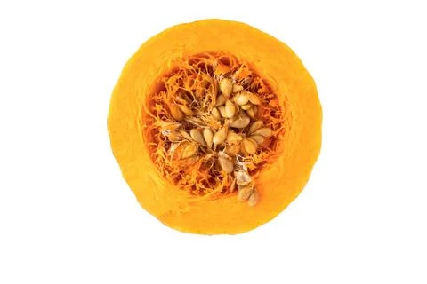 Shown is a cross section of an orange pumpkin with seeds on a white backgroun Stock Photos
