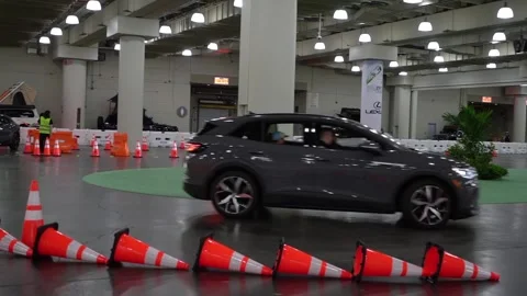 Showroom Display Featuring a Stylish Modern Vehicle Surrounded by Traffic Cones Vídeo Stock 291633150