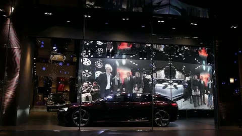 Showroom window with car and big electronic billboard screen in Beijing, China Stock Footage