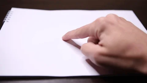 Shows a finger on a white sheet of paper. Shows a gesture here. Points to a Stock Footage 120427488