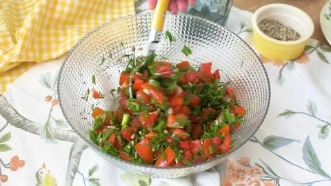 This shows how to prepare a salad using fresh tomatoes, dill, green onions,.. Stock-Footage 337188176