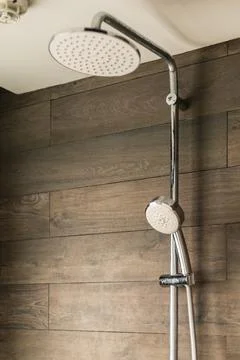 This shows a shower head mounted on a wall with a handheld shower option. The Stock Photos