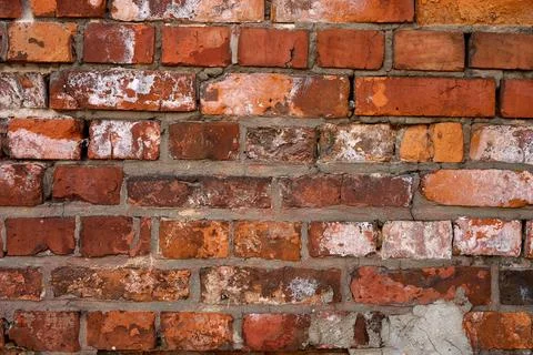 This shows a wall made of red and orange bricks in a building. The bricks hav Stock Photos