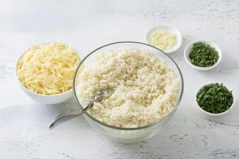 Shredded cauliflower, cauliflower rice or cauliflower couscous surrounded b.. Stock Photos