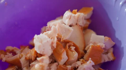 Shredded cooked chicken mixed with fork inside bright purple bowl, showing 스톡 동영상 343675165