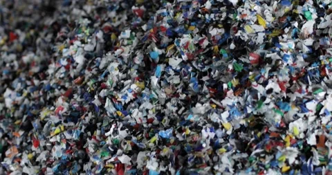 Shredded multi-colored plastic. Close-up. Waste recycling stage. The camera is Stock Footage 168092144