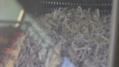 Shredded paper within an industrial machine falling in a shaft Stock Footage 154352698