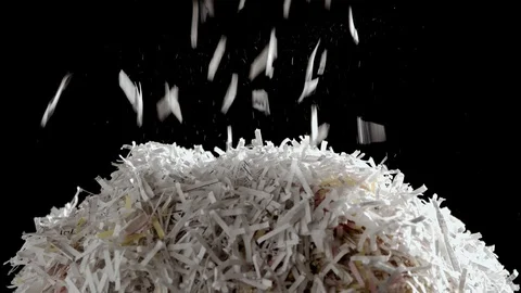 Shredded secret documents falling through the frame onto a pile of Stock Footage 122185462
