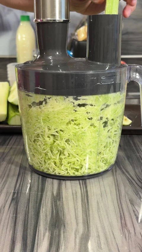 Shredding cabbage using a kitchen appliance shredder for meal preparation, sh Stock Footage 302470755