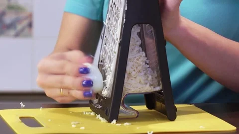 Shredding cheese on grater Stock Footage 74125859