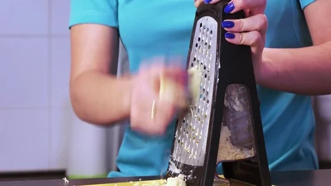 Shredding cheese on grater Stock Footage 74260927
