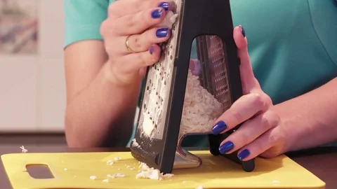 Shredding cheese on grater Stock Footage 74881857