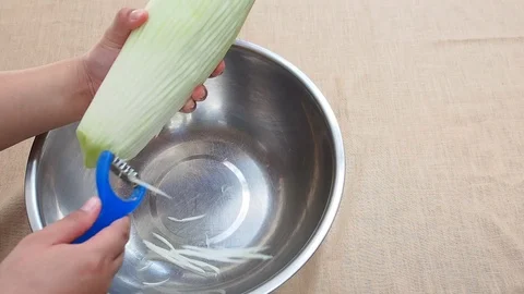 Shredding green papaya casually by slice peeler or papaya shredder Stock Footage 85556387