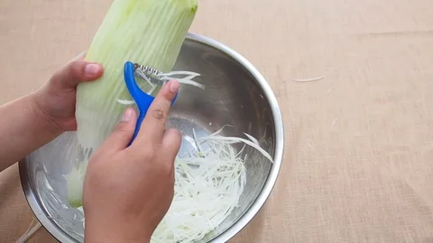 Shredding green papaya casually by slice peeler or papaya shredder Stock Footage 87194913