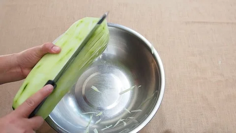 Shredding green papaya traditionally by knife, chopping step Stock Footage