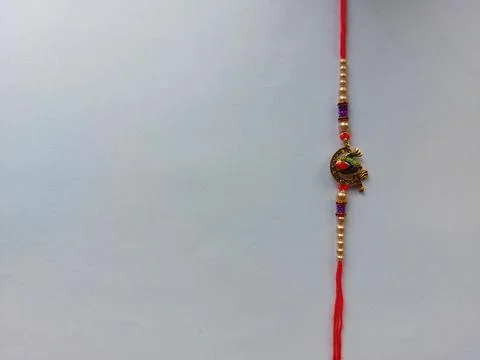 Shree krishna red rakhi(holy thread) with blank space on white background Stock Photos