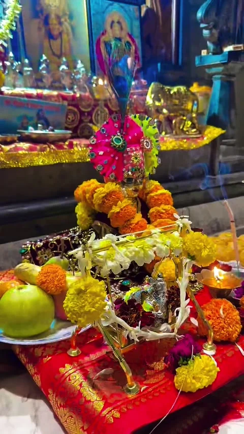 Shri Krishna Janmashtami Altar Setup with Flower Garlands &amp; Diya Flame Stock Footage 344752092
