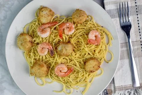 Shrimp and  scallops on top  of  spaghetti Stock Photos