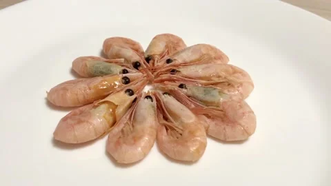 Shrimp and sliced lemon on a white plate. Puts a slice of lemon on shrimp. Stock Footage 132335199
