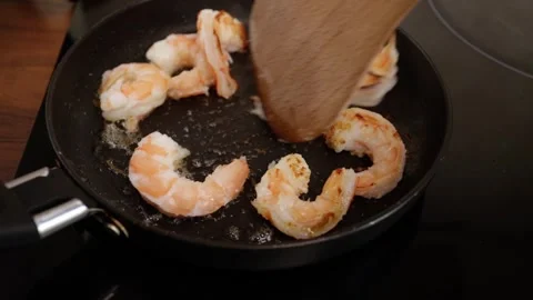 Shrimp frying in a pan, seafood grill, kitchen preparation, tasty meal. Stock Footage 271663404