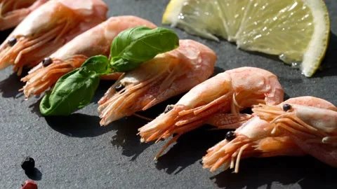 Shrimp with lemon on a black board Stock Footage 150183683
