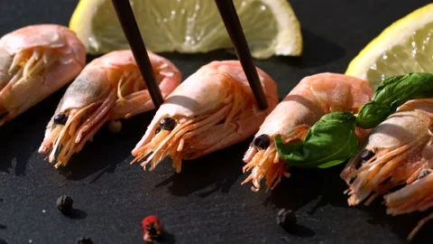 Shrimp with lemon on a black board Stock Footage 150276457