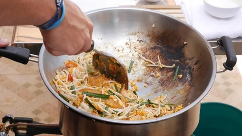 Shrimp noodles and egg fried in wok. Step by step cooking pad thai. Thai cuisine Stock Footage 106925834