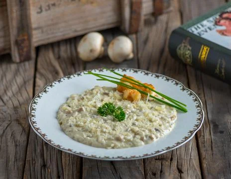 Shrimp risotto with mushroom served in a dish isolated on wooden background s Stock Photos
