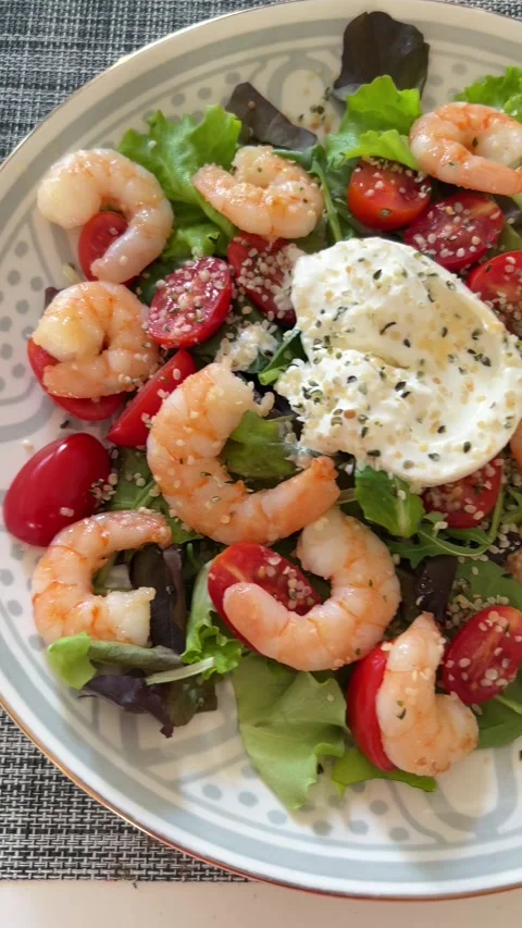 Shrimp salad featuring fresh mixed greens, cherry tomatoes Stock-Footage 333762733