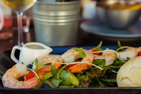 Shrimp salad on a table in a restaurant close-up. Healthy food Stock Photos