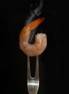 Shrimp strung on a fork Stock Photos